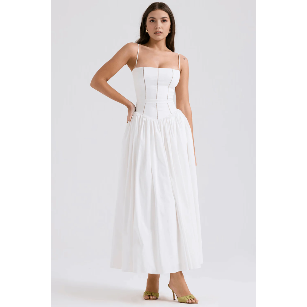 White floral maxi dress with spaghetti straps, fitted bodice, and flowing skirt