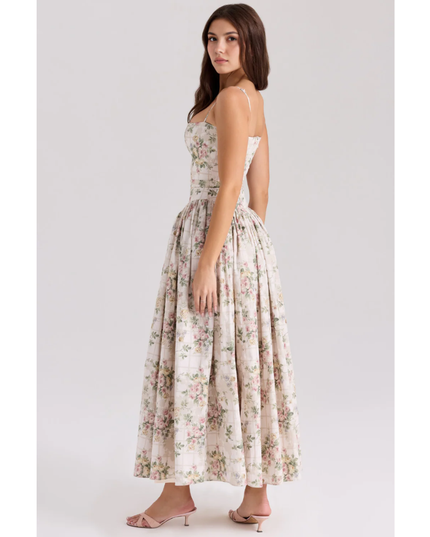 Side view of floral summer dress showing fitted waist and voluminous maxi skirt