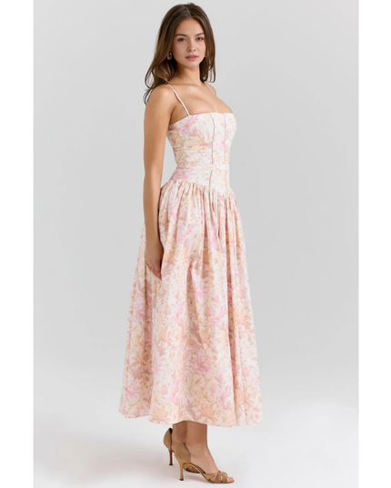 Women's pastel floral maxi dress with spaghetti straps, fitted waist, and soft pink print