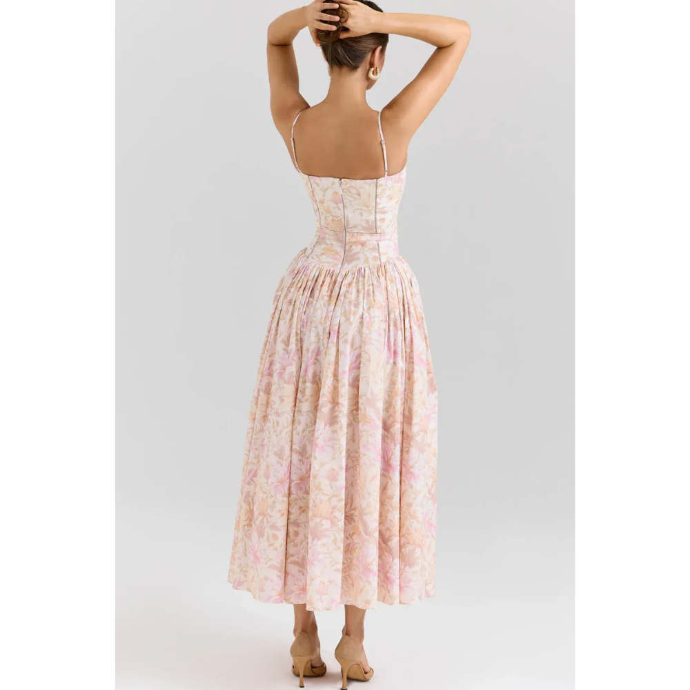Side view of pastel floral summer dress with fitted bodice and full midi length skirt