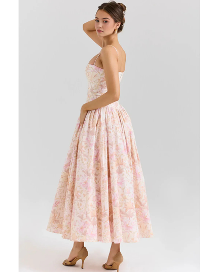 Back view of pastel floral maxi dress with open back, thin straps, and gathered waist