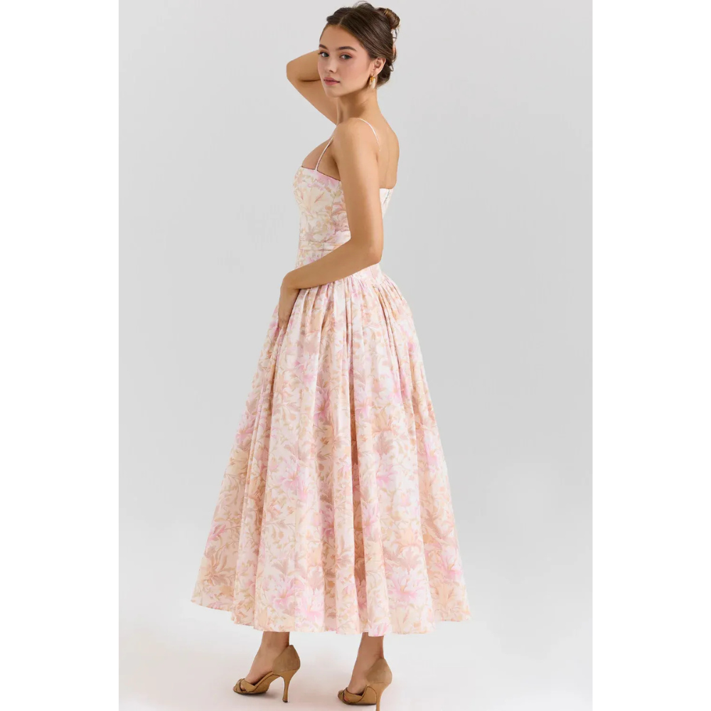 Back view of pastel floral maxi dress with open back, thin straps, and gathered waist