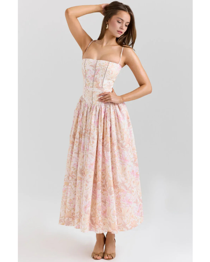 Women's floral maxi dress in pastel pink with straps, fitted bodice, and flowing skirt