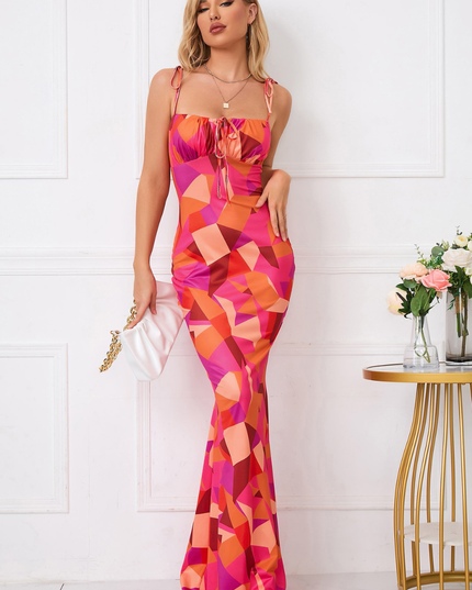 Front view of colorful geometric maxi dress with square neckline, tie straps, and fit