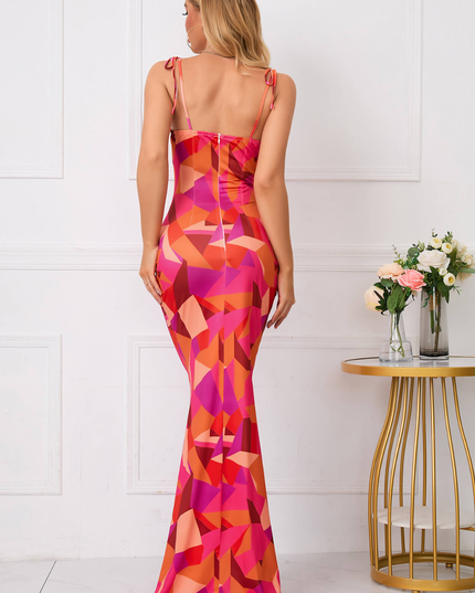 Back view of a pink and orange floral maxi dress with tie straps and fitted silhouette
