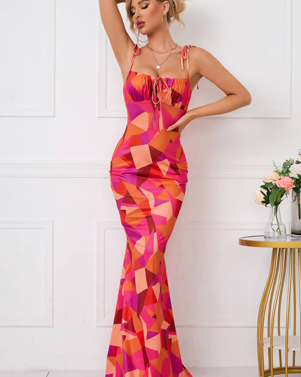 Front view of a square neck floral maxi dress with tie straps and bodycon fit in pink and orange