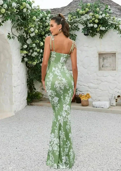 Back view of green floral maxi dress with open back, tie shoulder straps, and long fitted skirt