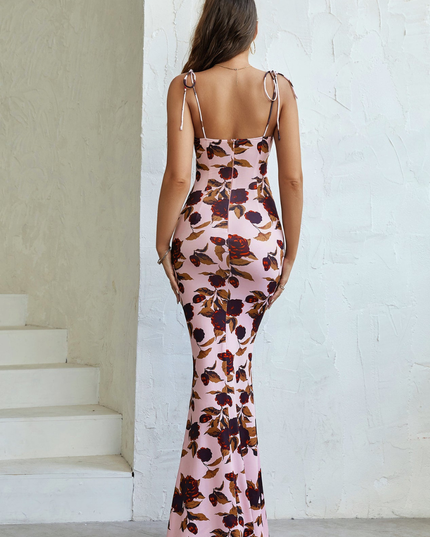Back view of pink floral maxi dress showing open back, tie straps, and floor-length fit
