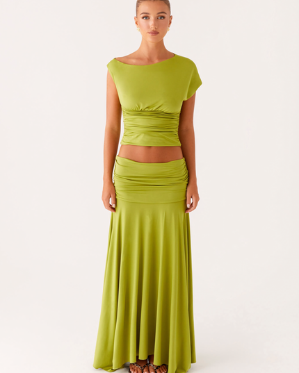 Front full-length view of lime green summer dress with boat neck, ruched bodice, and long skirt