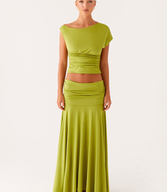 Front full-length view of lime green summer dress with boat neck, ruched bodice, and long skirt