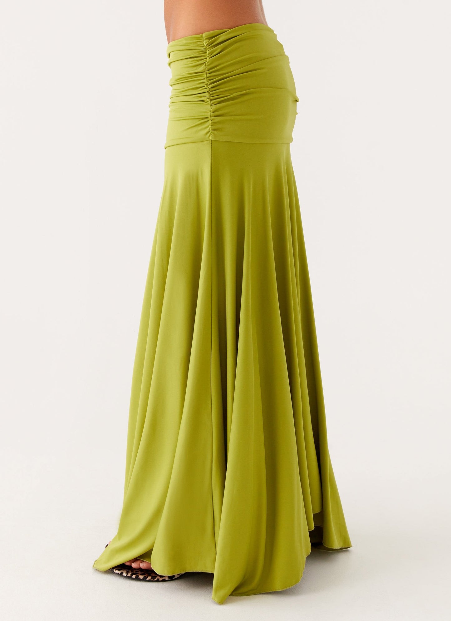 Close-up side view of lime green ruched waist maxi dress with smooth boat neck neckline