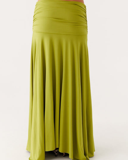 Back close-up of lime green maxi dress showing ruched waist panel and flowing skirt fabric