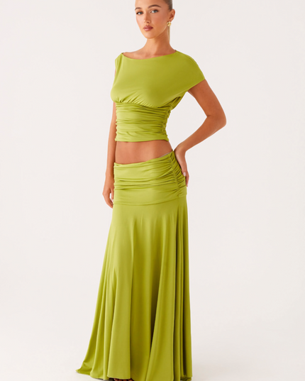 Front view of lime green ruched boat neck maxi dress with fitted waist and flowing skirt