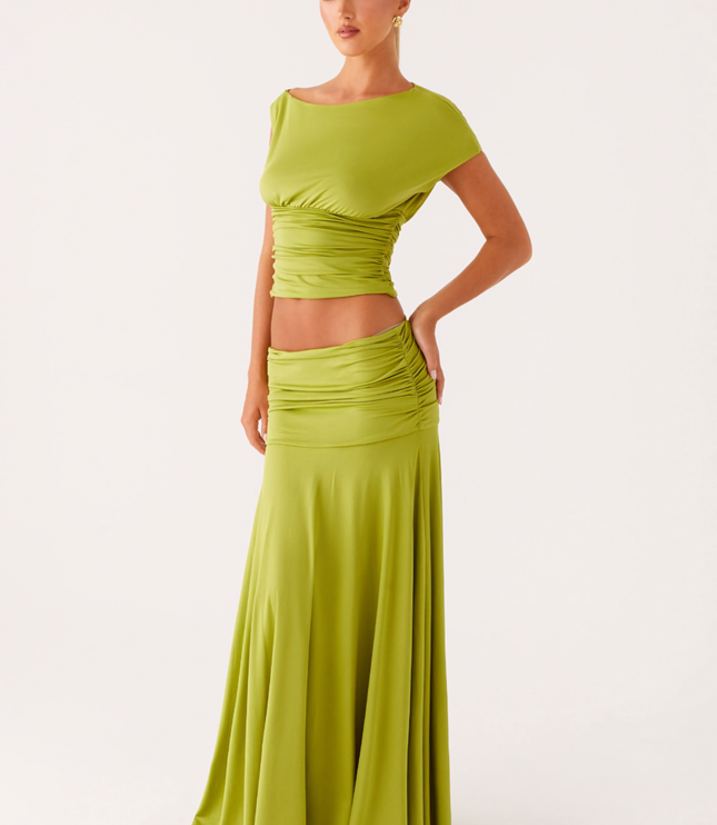 Front view of lime green ruched boat neck maxi dress with fitted waist and flowing skirt