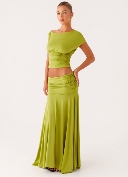 Front view of lime green ruched boat neck maxi dress with fitted waist and flowing skirt