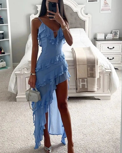 Model shot of a light blue ruffled spaghetti strap midi dress styled with heels and handbag