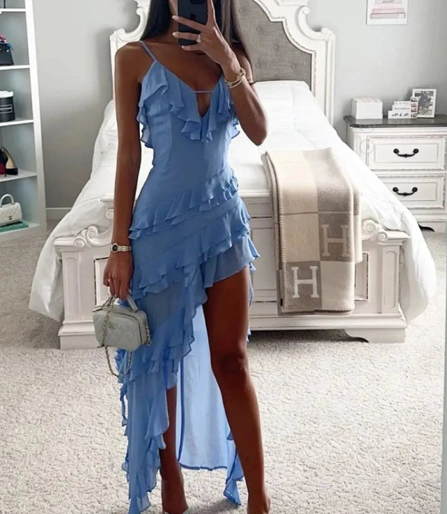 Model shot of a light blue ruffled spaghetti strap midi dress styled with heels and handbag