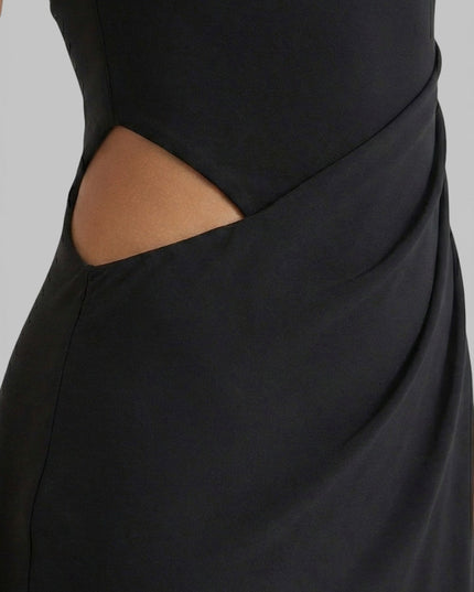 Close-up of black summer maxi dress showing side cut out and draped waist detail