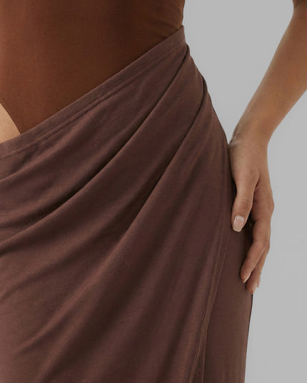 Close-up of brown summer dress showing draped waist and side cut out detail