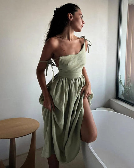 Side view of sage green summer linen dress with one-shoulder tie detail and gathered skirt