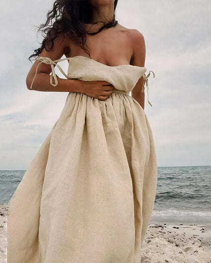 Beige strapless linen maxi dress with tied side straps and loose flowing summer skirt
