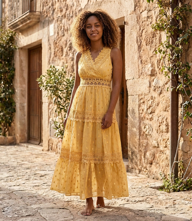 Yellow floral maxi dress with lace trim and V-neck, shown on model outdoors