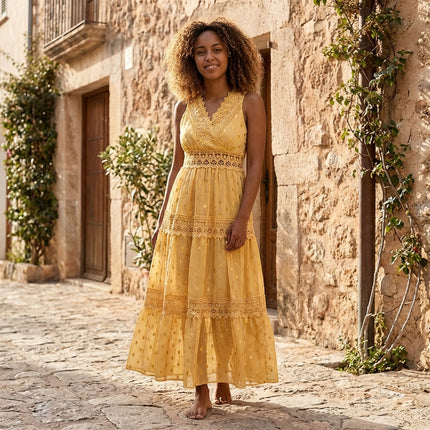 Yellow floral maxi dress with lace trim and V-neck, shown on model outdoors