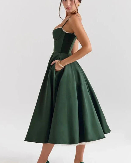 Back angled view of dark green midi wedding guest dress with open back and full skirt