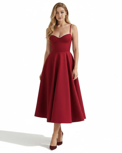 Front view of a burgundy midi dress with thin straps and a fitted corset-style bodice
