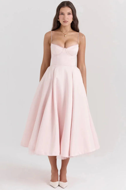 Blush pink midi dress with spaghetti straps and full skirt for wedding guest