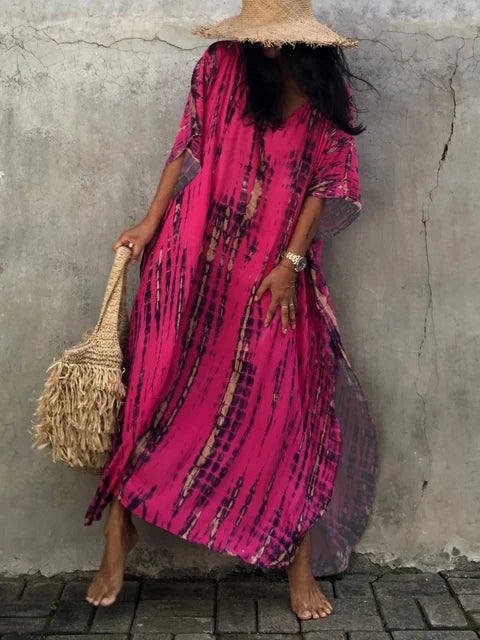Bright pink tie dye maxi dress with V-neck, sheer loose sleeves, and relaxed boho summer dress shape