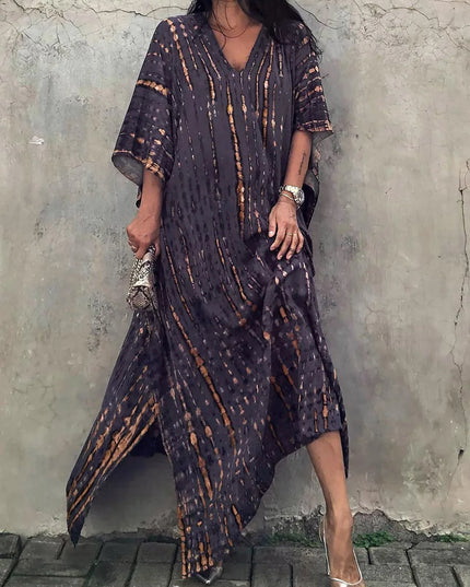 Dark charcoal tie dye maxi dress with orange accents, V-neck, and asymmetrical hem