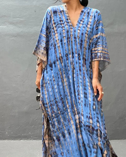 Blue tie dye maxi dress with V-neckline and wide sleeves in a relaxed summer dress style