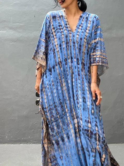 Blue tie dye maxi dress with V-neckline and wide sleeves in a relaxed summer dress style
