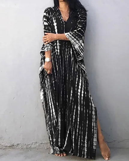 Black tie dye maxi dress with white streaks, long loose sleeves, and a full-length summer dress cut