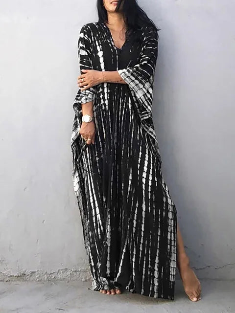 Black tie dye maxi dress with white streaks, long loose sleeves, and a full-length summer dress cut