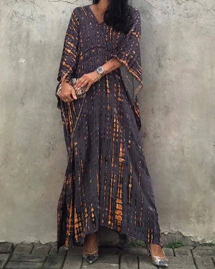 Dark charcoal tie dye maxi dress with orange streaks, V-neck, and relaxed boho summer dress style