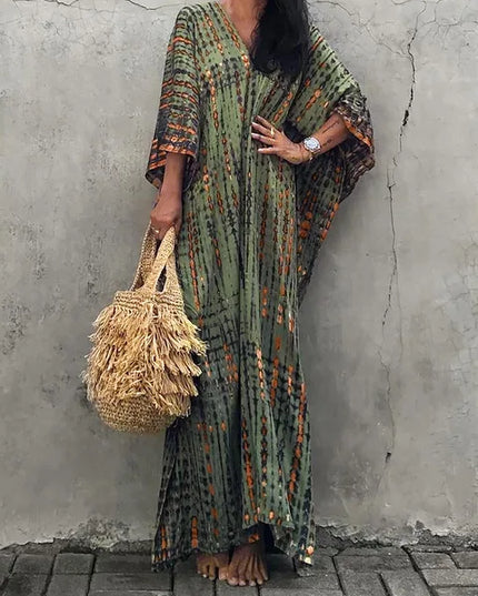 Olive green tie dye maxi dress with orange accents, wide sleeves, and a flowing bohemian summer dress fit
