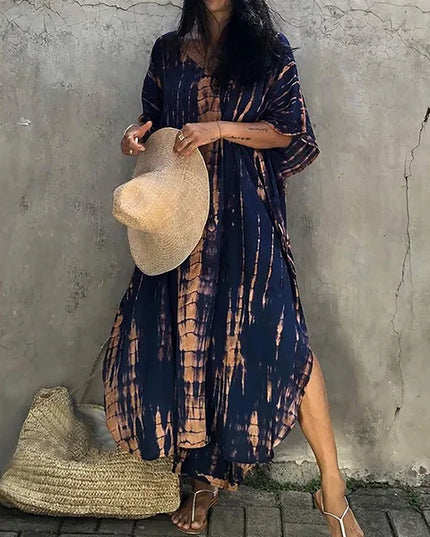 Navy and tan tie dye maxi dress with side slit, loose sleeves, and airy beach-ready summer dress style