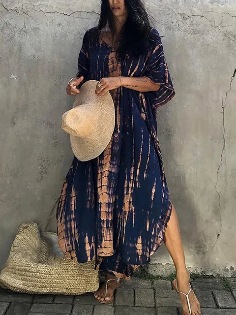 Navy and tan tie dye maxi dress with side slit, loose sleeves, and airy beach-ready summer dress style