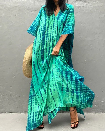 Teal and green tie dye maxi dress with loose sleeves and flowing summer dress silhouette