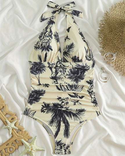 Flat lay tropical one piece swimsuit with halter neck tie and black palm print on cream fabric