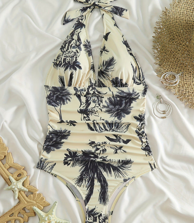 Flat lay tropical one piece swimsuit with halter neck tie and black palm print on cream fabric