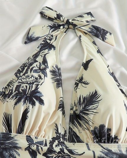 Close-up of halter top swimsuit neckline with tropical leaf print and gathered bust detail