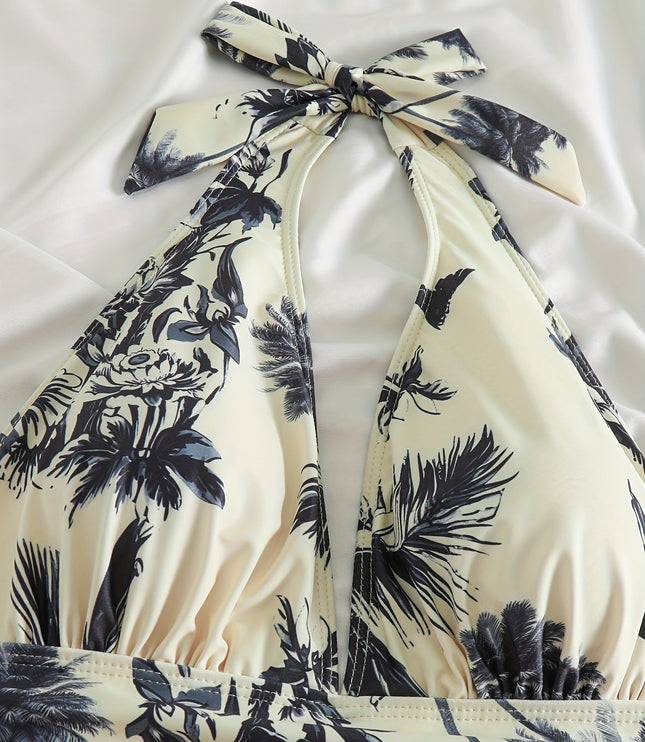Close-up of halter top swimsuit neckline with tropical leaf print and gathered bust detail