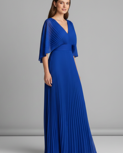 Side view of royal blue pleated maxi dress with V neck and draped cape sleeves