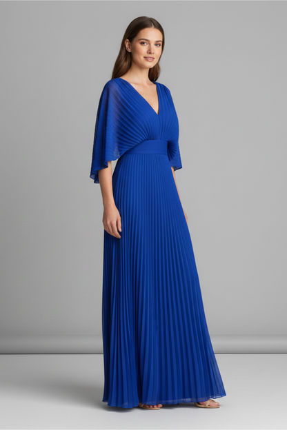 Side view of royal blue pleated maxi dress with V neck and draped cape sleeves