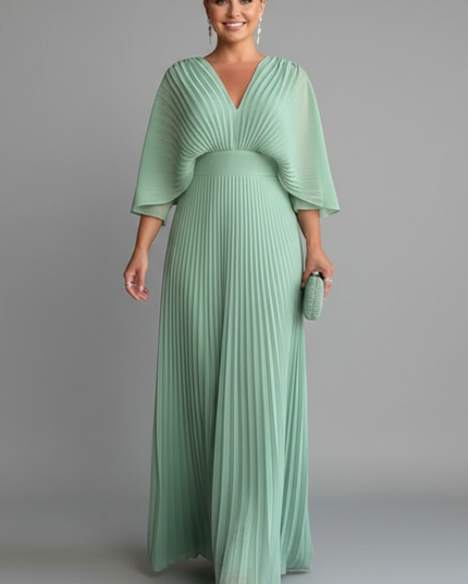 Soft green pleated maxi dress with V neck, sheer cape sleeves, and fitted waist