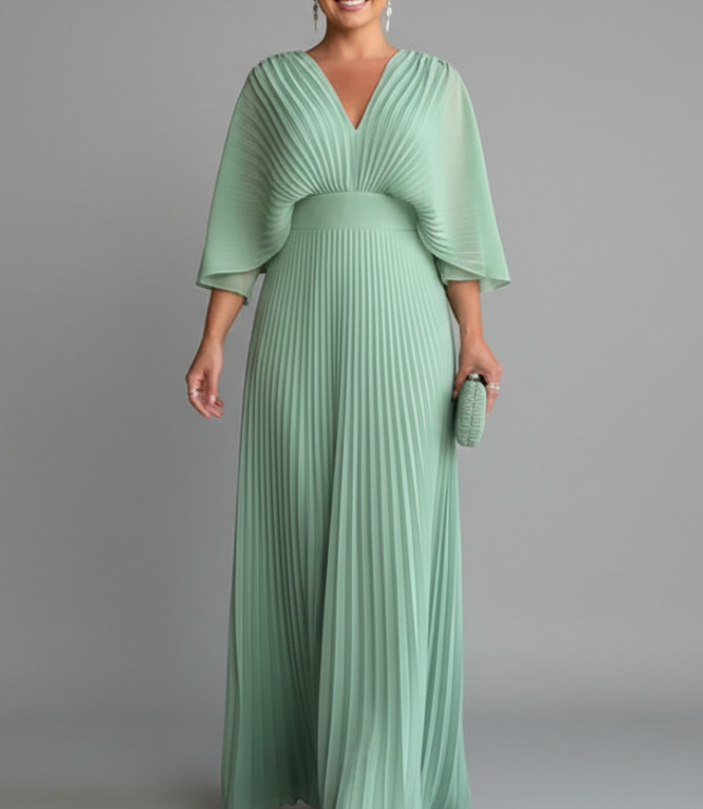 Soft green pleated maxi dress with V neck, sheer cape sleeves, and fitted waist