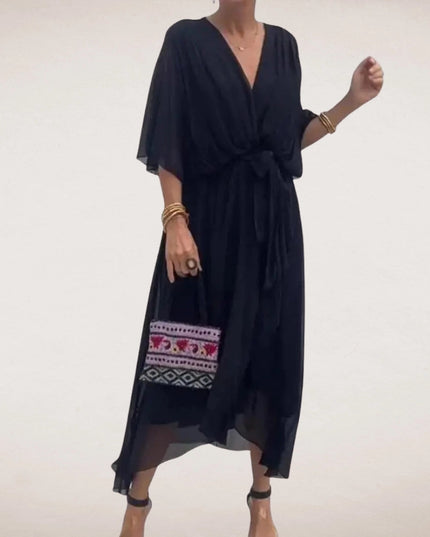 Black midi wrap dress with V neck, sheer flowing sleeves, and relaxed summer silhouette